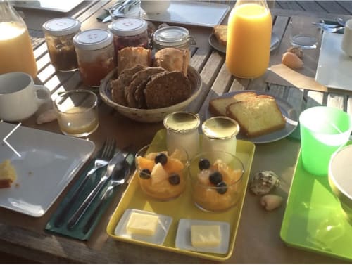 Breakfast spread at Cote Et Dune hotel including pastries, jams, juice, and yogurt desserts in Biscarrosse Plage.