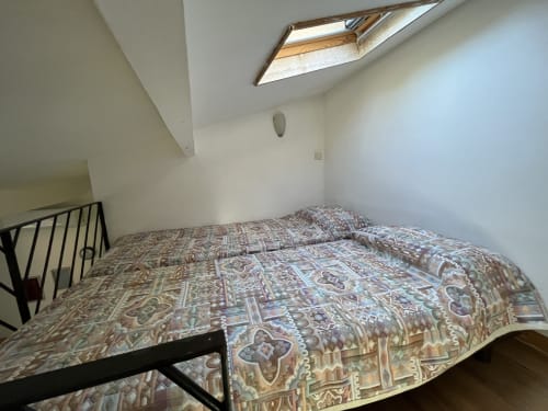 Chambre mezzanine avec linge de lit à motifs et puits de lumière à la villa Le Maquis Plage, Poggio-Mezzana