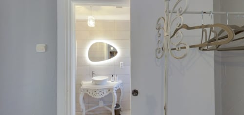 Elegant bathroom in Romance en Berry room at Aux Prés Du Berry with illuminated mirror and ornate fixtures