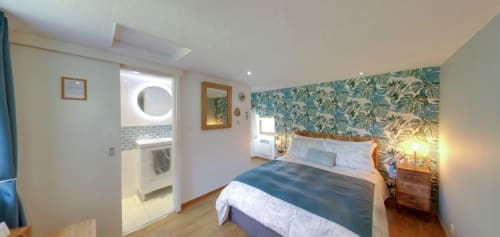 Exotic Berry room at Aux Prés Du Berry B&B with queen bed, floral wallpaper, ensuite bathroom, and garden views in Chavin,