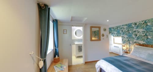 Exotic Berry room at Aux Prés Du Berry with tropical wallpaper headboard, garden view, and modern amenities in Chavin, France