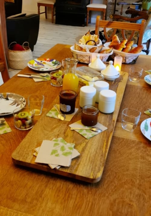 Breakfast table at Aux Prés Du Berry B&B with fresh pastries, jams, juice, and fruit spreads in Chavin, France.