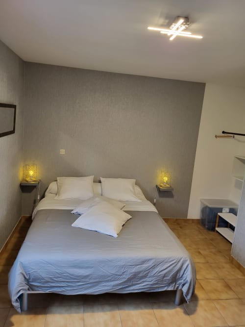 Chambre moderne de l'Hôtel Cheverny La Vie Est Belle avec lit queen-size, literie crème, éclairage ambiant et parquet
