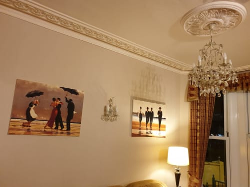 Elegant hotel room at The Sands with classical ceiling rose, crystal chandelier, and decorative artwork on cream walls