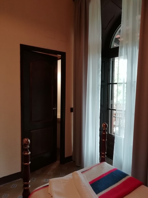 Habitación Carlet|Sant Martí de Centelles -Dormitorio donde reinan la calma y la sensación de recogimiento; situado en la planta noble del edificio, con vistas a los jardines de a mediodía y a la piscina de agua salada, siempre a punto para los huéspedes en tiempos de veraneo.