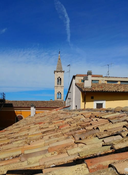 Sulmona historic bell tower and terracotta roofs at Stella CasaBono hotel with blue sky view