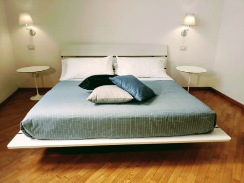 Stella CasaBono Junior Suite with double bed, blue bedding, white pillows, modern lamps, wooden floor, and minimalist decor