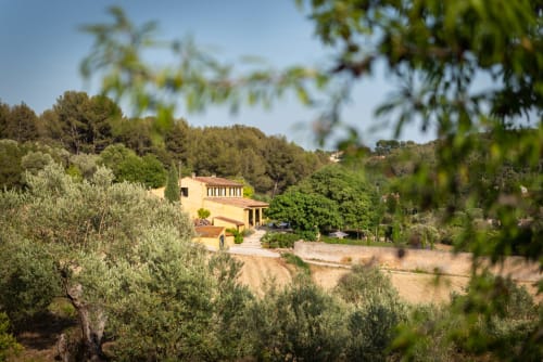 Saint Martin B&B nestled in olive groves near Ollioules, France with terracotta buildings and Mediterranean landscape