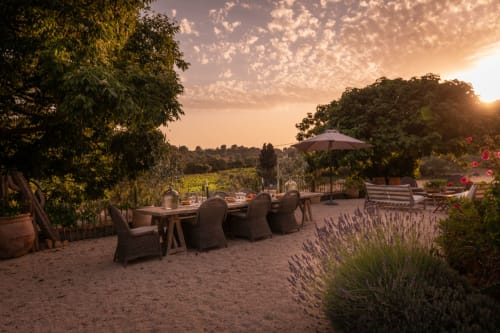 Sunset terrace at Saint Martin B&B in Ollioules with dining table, lavender garden, and vineyard views