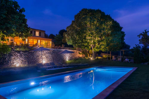 Saint Martin B&B pool at twilight in Ollioules, France, with illuminated stone wall and house