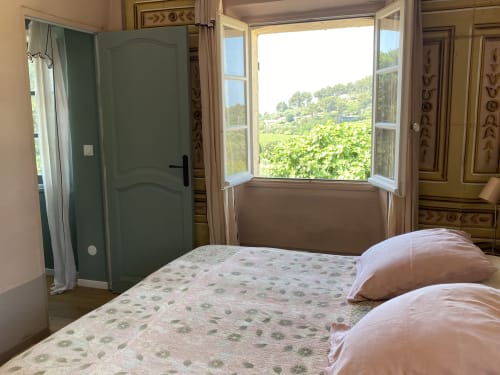 Bright bedroom at Saint Martin B&B in Ollioules with countryside views through open windows
