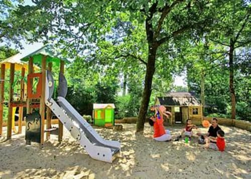 Aire de jeux pour les enfants avec cabanes, toboggan, trampoline, etc.