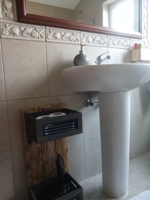 Modern pedestal sink in bright bathroom with decorative tile trim at Kindnessmoon villa in Óbidos, Portugal