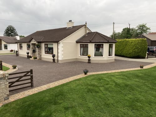 Steeple View B&B Guesthouse in Co. Donegal features a modern cream-colored bungalow with dark roof, spacious driveway, and