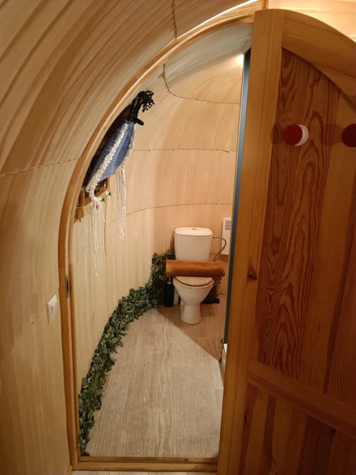 Rustic wooden toilet interior at Les Refuges Du Chalet cottage with decorative elements and natural finishes