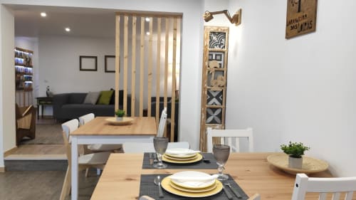 Dining area in Laranjeira das Loiras cottage in Óbidos with table settings, wooden furniture and living room view