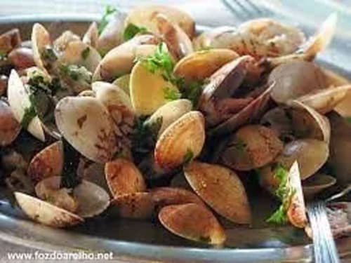 Cooked clams garnished with fresh herbs at Kindnessmoon B&B in Óbidos, Portugal