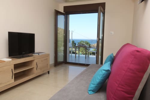 Habitación Lobeiro en A Ballenera de Caneliñas de Cee con balcón con vistas al mar, mobiliario moderno y TV de pantalla plana