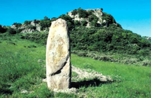 Piedra menhir antigua en un paisaje verde cerca de Torre Grande Oristano, Italia