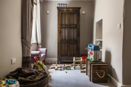 Three Little Pigs Luxury Cottage play room with toys, wooden furniture, and sitting area in Blandford Forum