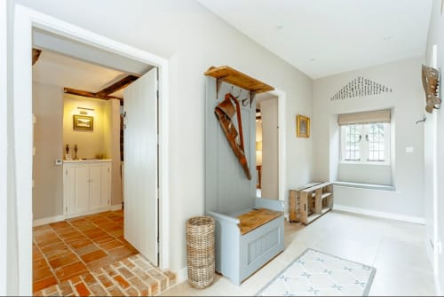 Three Little Pigs Luxury Cottage entryway in Blandford Forum featuring mudroom with bench, hooks, and door to bathroom