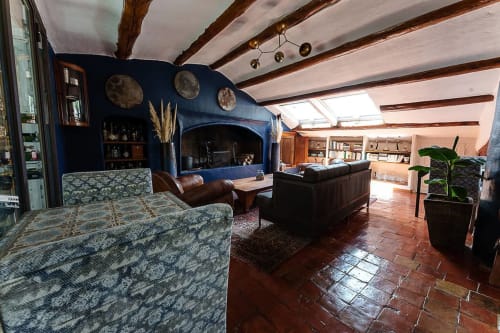 Geräumiges Loft-Wohnzimmer in La Bouscatière in Moustiers-Sainte-Marie mit blauem Akzentwand, freigelegten Balken und rustikalem Stil