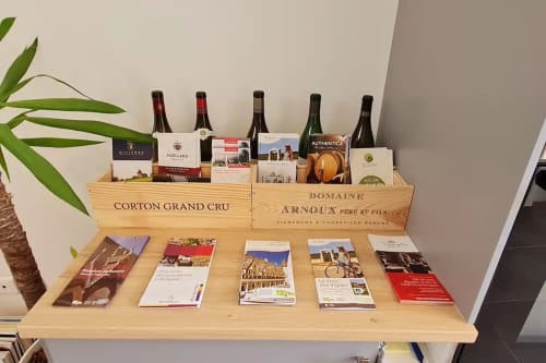 Présentation de bouteilles de vin avec les coffrets Corton Grand Cru et Domaine Arnoux à la Conciergerie Des Climats, hôtel à Beaune, France