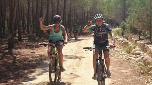 Two cyclists riding on a forest trail near Posada, Italy, perfect for outdoor activities at B&B Eleonora D'Arborea