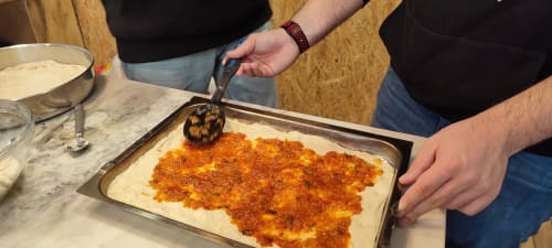 Chef preparing traditional Portuguese pizza at Kindnessmoon BnB in Óbidos, Portugal