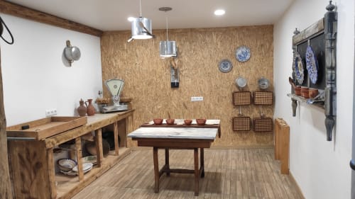 Rustic kitchen display at Kindnessmoon B&B in Óbidos with wooden furniture, traditional pottery, and vintage decor