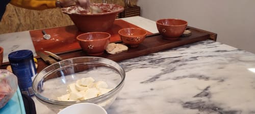 Tea ceremony setup at Kindnessmoon guesthouse in Óbidos, Portugal with terracotta cups and marble table