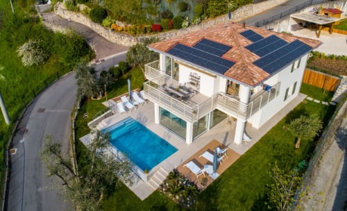 Verdolivo B&B aerial view with solar panels, pool, and manicured gardens in Sale Marasino
