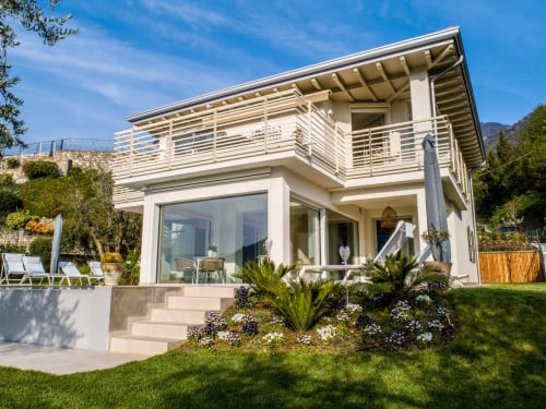 Verdolivo B&B in Sale Marasino: Modern white villa with terrace, palm trees, and mountain views