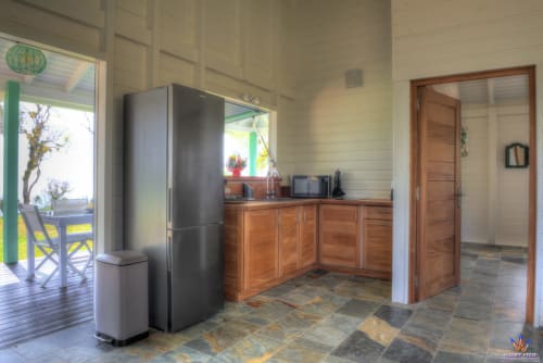 Modern kitchen area in Kaz'Quisqualis cottage at Le Domaine De L'ilet, Saint-Claude, Guadeloupe with stainless appliances