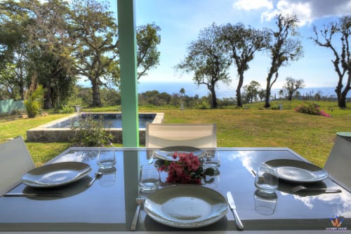 Elegant dining table set with ocean view at Le Domaine De L'ilet cottage in Saint-Claude, Guadeloupe