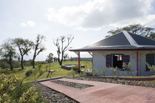 Modern cottage at Le Domaine De L'ilet in Saint-Claude, Guadeloupe with red brick patio, countryside views, and tropical