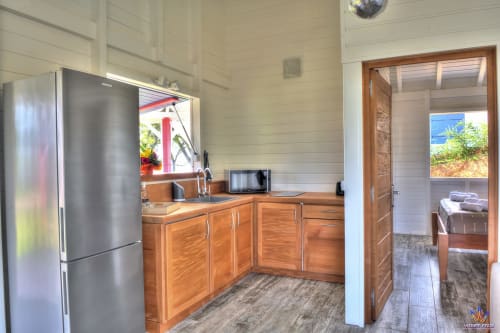 Modern kitchen in Kaz'Mussaenda cottage at Le Domaine De L'ilet, Saint-Claude, Guadeloupe with stainless steel appliances and