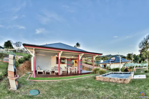 Kaz'Mussaenda cottage at Le Domaine De L'ilet in Saint-Claude, Guadeloupe with red accents, pool, and garden views