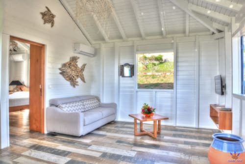 Bright cottage living room at Le Domaine De L'ilet in Saint-Claude, Guadeloupe, with sea view and modern furnishings.