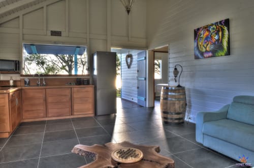 Spacious Kaz'Samana cottage interior with kitchen, sitting area, and sea view at Le Domaine De L'ilet, Saint-Claude