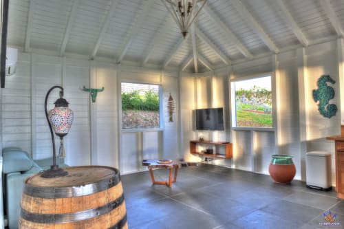 Modern Kaz'Samana cottage at Le Domaine De L'ilet in Saint-Claude with barrel decor, TV, sitting area, and sea views through