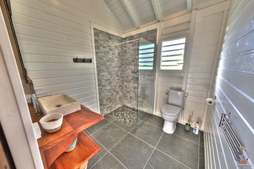 Modern bathroom in Kaz'Samana cottage at Le Domaine De L'ilet, Saint-Claude, Guadeloupe, with walk-in shower and terracotta