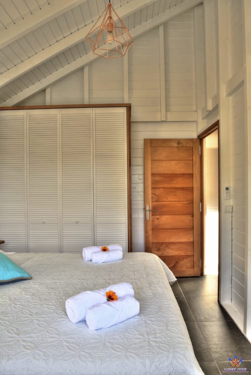 Bright bedroom in Kaz'Samana cottage at Le Domaine De L'ilet, Saint-Claude with twin beds, geometric pendant light, and