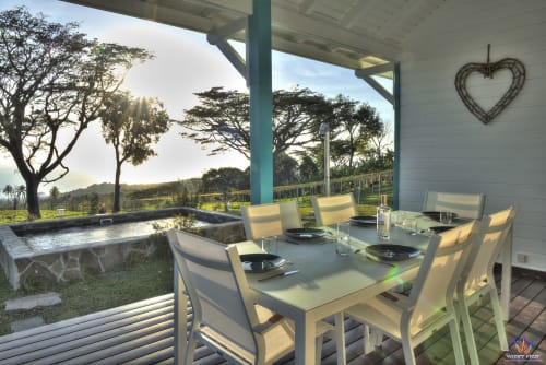 Kaz'Samana cottage dining area at Le Domaine De L'ilet with infinity pool, ocean view, and tropical landscape in