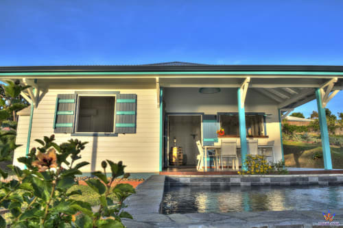Kaz'Samana cottage at Le Domaine De L'ilet in Saint-Claude, Guadeloupe, featuring turquoise trim, covered porch, and sea view