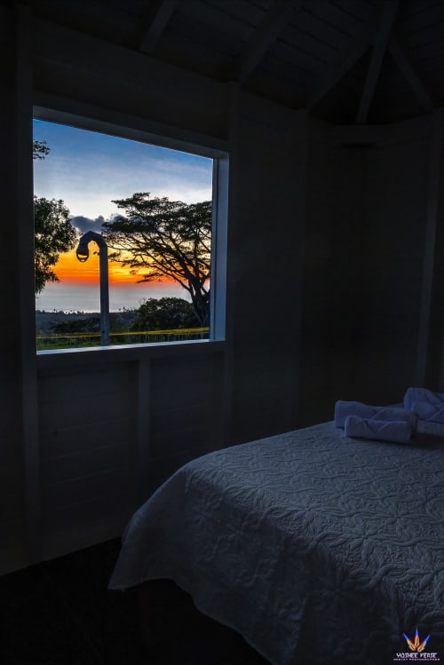 Bedroom with sea view at Le Domaine De L'ilet, Saint-Claude Guadeloupe, sunset over ocean and trees