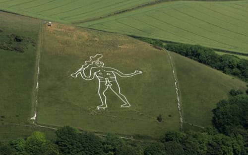 The Cerne Abbas Giant chalk figure on hillside near Three Little Pigs hotel, Blandford Forum