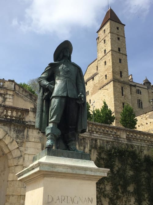 D'Artagnan statue with medieval tower in Saint-Puy, near Le Rêve d'Alice bed and breakfast
