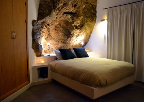 master bedroom with natural rock formation