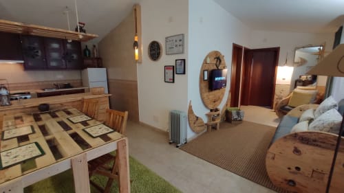 Open-plan villa interior in Óbidos with dining table, kitchen, living area, and wooden furniture at Kindnessmoon